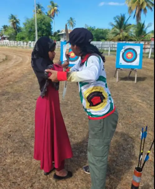 Teaching a visually impaired archer in Berbice, 2023