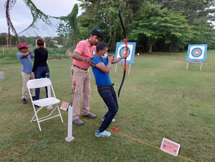 Teaching a differently abled archer at the Annual Orphans Summer Camp, 2022